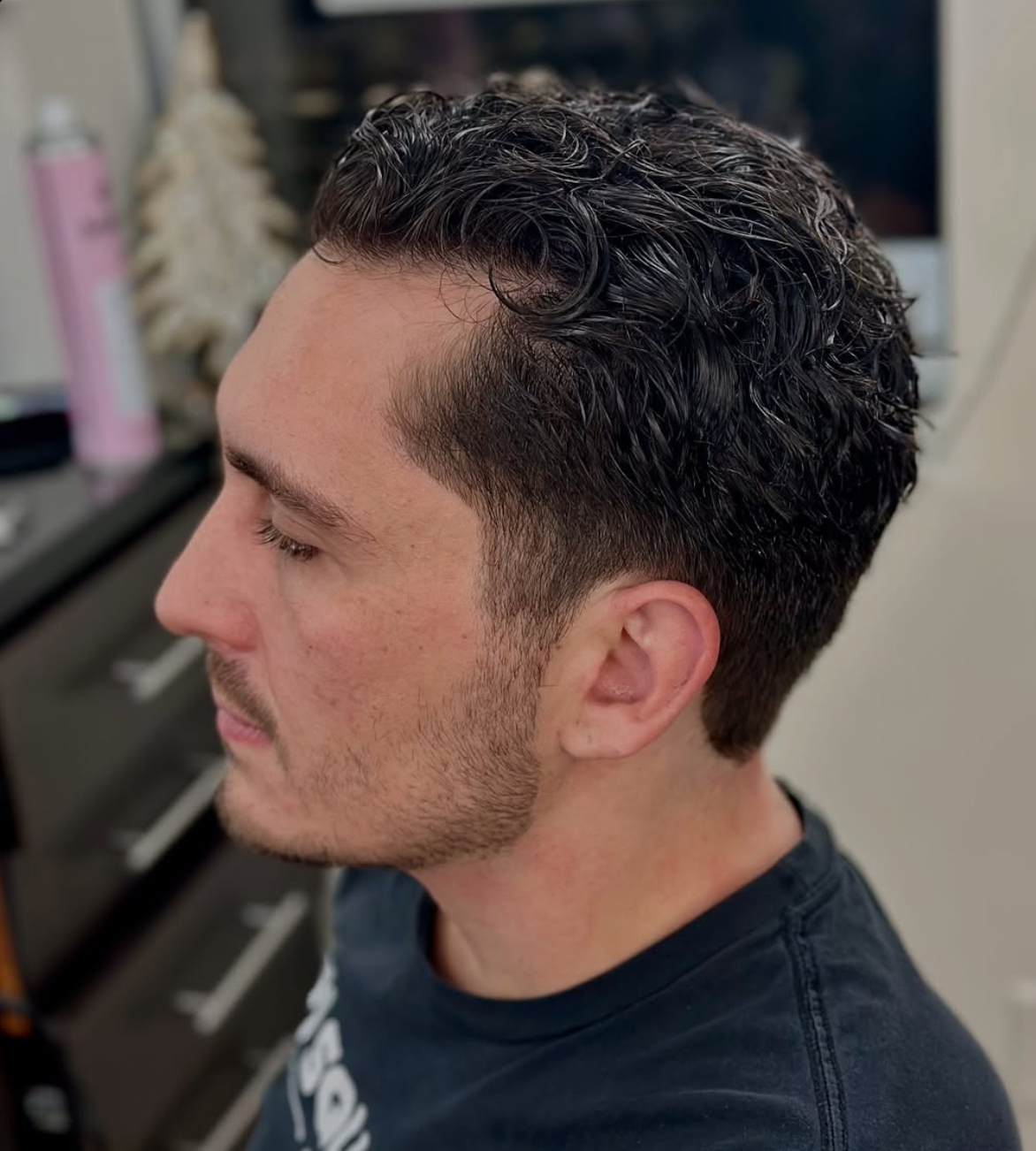 Men's textured curly cut with a clean tapered fade